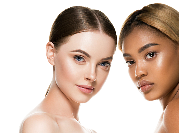 Two women with radiant, healthy skin of different complexions pose side by side, representing ORY Skincare’s inclusive commitment to quality, trust, and customer satisfaction under its return policy.