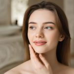 Woman with smooth, balanced complexion applying hydrating lotion — ORY Skincare moisturizer for normal skin.