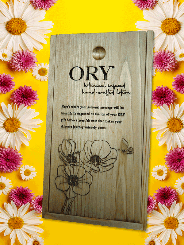 ORY Wooden Gift Box with Custom Engraving | Botanical Skincare Gift Packaging ORY wooden gift box with engraved logo and floral illustration, displayed on a vibrant yellow background framed by daisies and pink flowers, highlighting personalized botanical skincare gifting.
