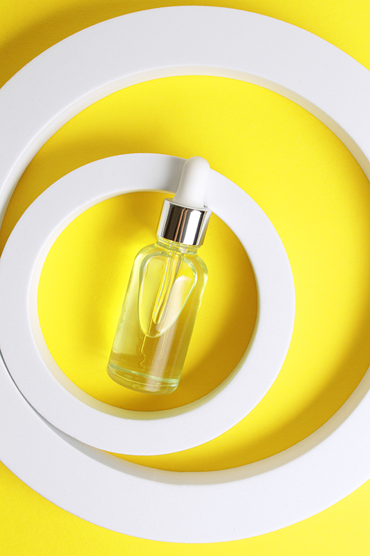 Glass dropper bottle with golden liquid representing Polysorbate 60, a non-ionic emulsifier used in skincare to stabilize oil-and-water formulations.