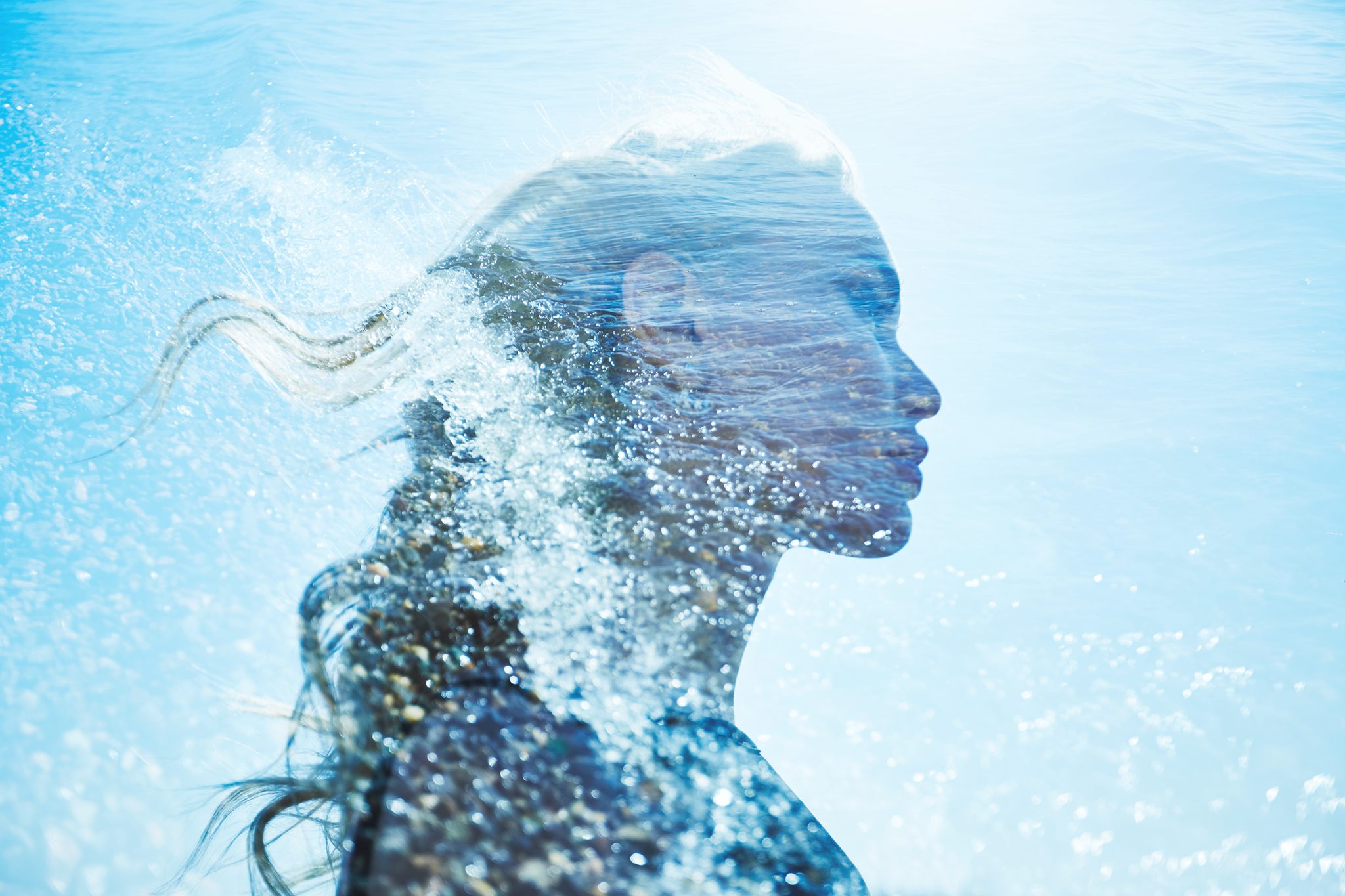 Abstract silhouette of a woman formed by flowing water and light, symbolizing ionized water in skincare and ORY’s science-driven hydration philosophy.