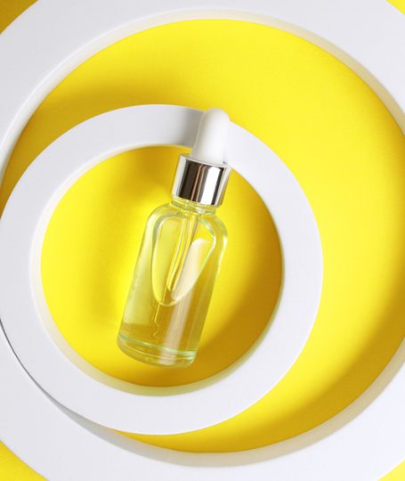 Glass dropper bottle with golden liquid representing Polysorbate 60, a non-ionic emulsifier used in skincare to stabilize oil-and-water formulations.