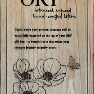 ORY wooden gift box lid with engraved logo, floral illustration, and personalized message space, showcasing handcrafted botanical skincare packaging.